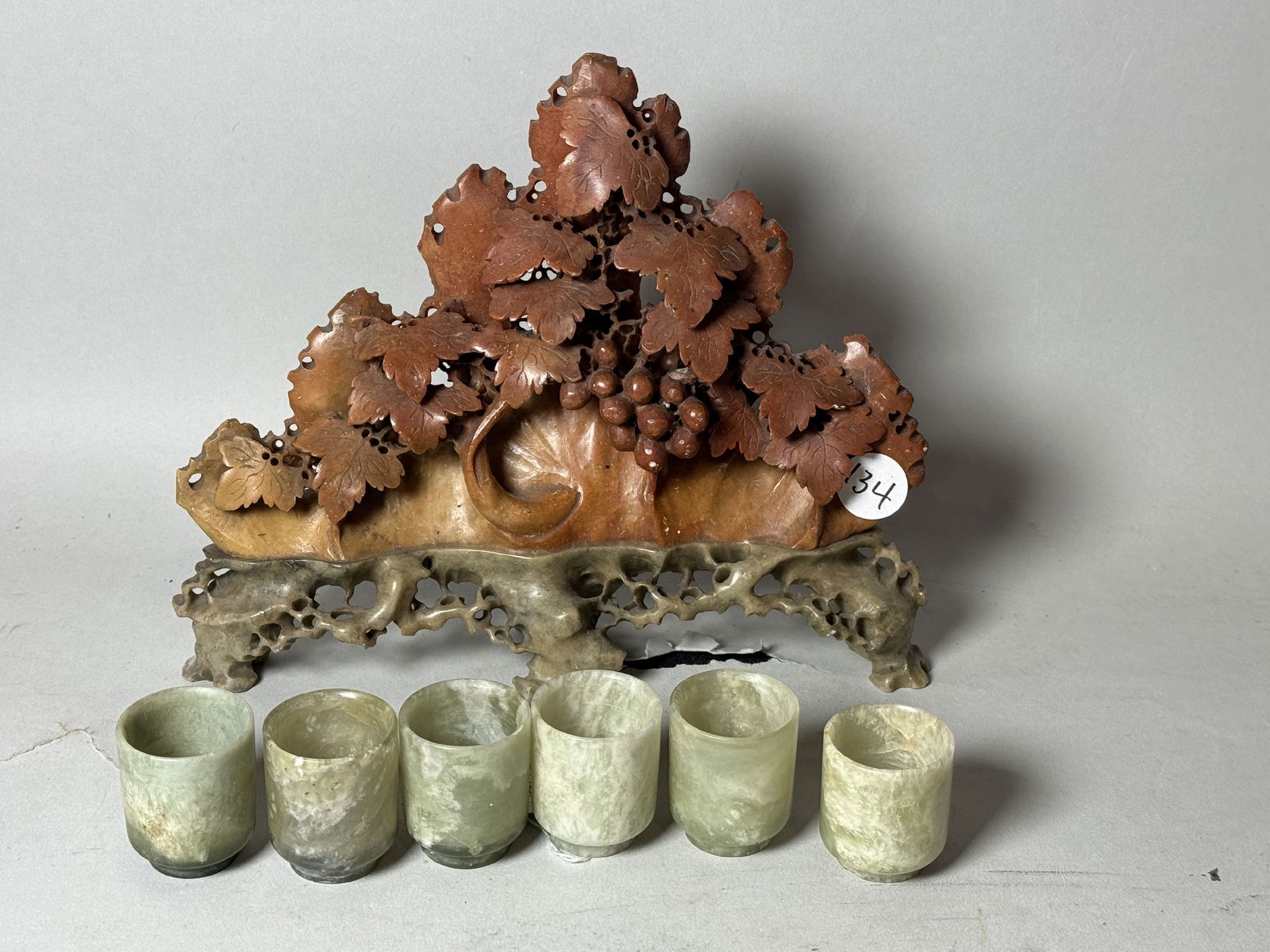 A CARVED HARDSTONE MOUNTAIN AND SIX JADE CUPS, 8.5" X 6.5" AND 1" DIAMETER X 1.5" TALL RESPECTIVELY (1 of 5)