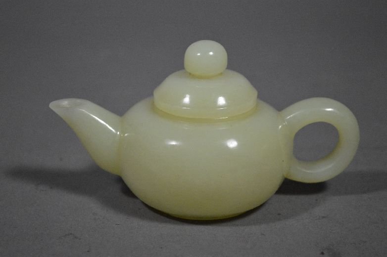 Carved jade tea pot: jade tea pot, china, white jade carved very finely. 2 1/4" x 4 1/2"
