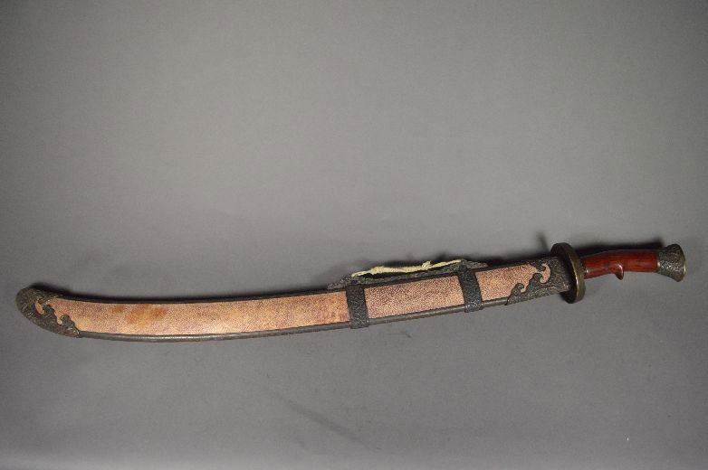 Military sword: military sword, china, with shark skin sheath, blade inlaid with gold line as Chinese characters, with carved wood handle. 36 1/2"