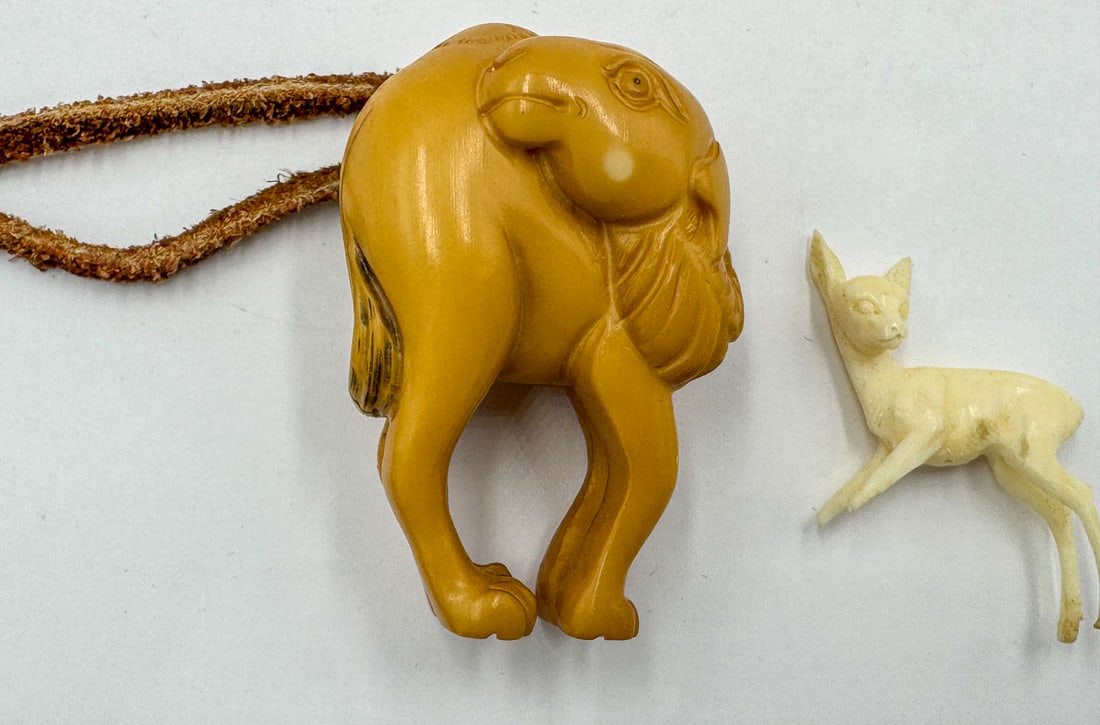 A CARVED NETSUKE OF A CAMEL, 2": A CARVED NETSUKE OF A CAMEL, 2"