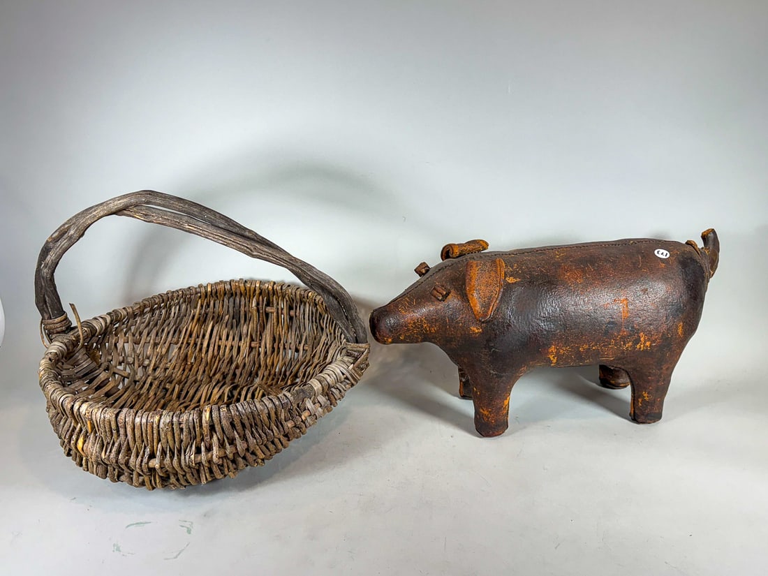 A LEATHER PIG FOOTSTOOL AND A LARGE HANDMADE BASKET, 22" X 8" X 12" AND 20" X 14" (1 of 5)