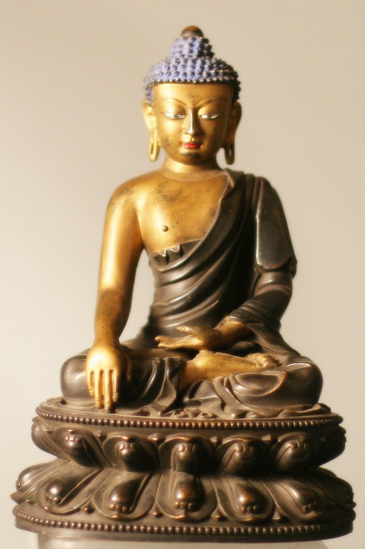 Qing Dynasty Gilt Bronze Buddha: Bronze Buddha, china, Qing dynasty, gilt bronze Buddha sitting cross-legged on a lotus throne, left hand palm up, right hand drooping naturally, finger ground, which represents the traditional gesture