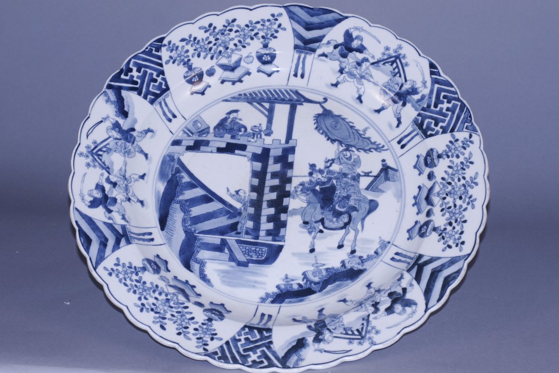 blue and white plate: blue and white plate, china, decorated war story., kangxi mark on base. Flower shaped rim. 17.5" diameter