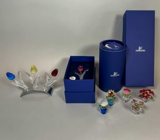 8 SWAROVSKI CRYSTAL FLOWERS SOME WITHOUT BOXES. 4" AND SMALLER W/ STANDS