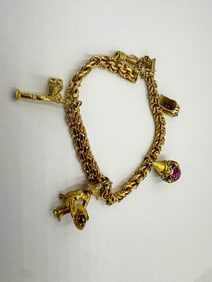 18K GOLD CHARM BRACELET, 51.37 GRAMS