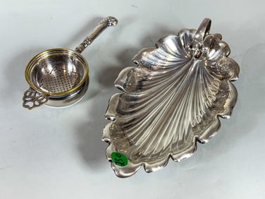 STERLING SILVER LEAF DISH AND A STERLING SILVER HANDLED TEA STRAINER, 8.1 OZT