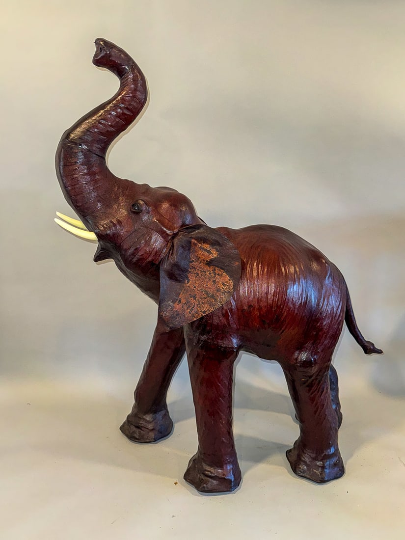 A LEATHER ELEPHANT, 28" X 9" X 36": A LEATHER ELEPHANT, 28" X 9" X 36"