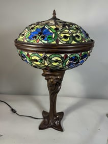 A FIGURAL TIFFANY STYLE BRONZE LAMP, 15" X 28"