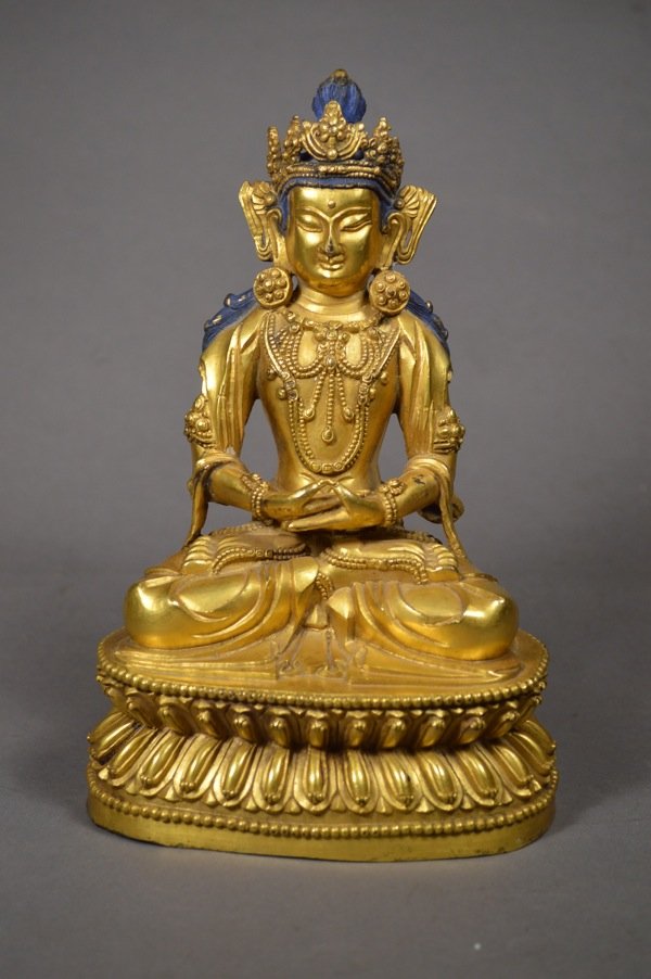 Chinese Gilt Bronze Buddha Statue: Gilt Bronze Buddha, 18c. Sitting cross-legged on lotus flower seat, hands placed in same way on his knees, and placed in buddhist concentration position. 8 3/4" x 5"