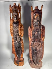 A PAIR OF CARVED SOUTHEAST ASIAN CARVED FIGURES, 34" X 8" X 5"