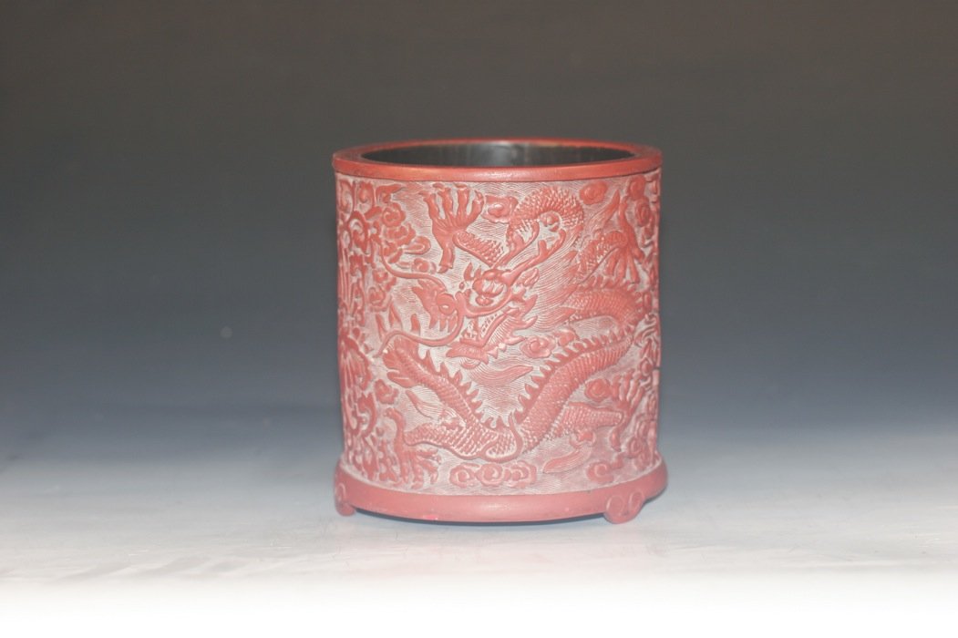 Red Lacquer Brush Pot: red lacquer brush pot, china, decorated with carved flower and dragon pattern, four Chinese character mark on base, 5'' x 5''