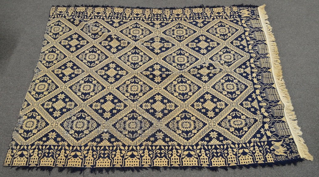 Overshot Coverlet, Signed: Blue and White Overshot Coverlet, signed ''Knox County, Ohio 1855 Adam Yearous.'' 70'' x 94''. Areas of minor wear, some stains, some fraying along once edge. Intact, no major damage.