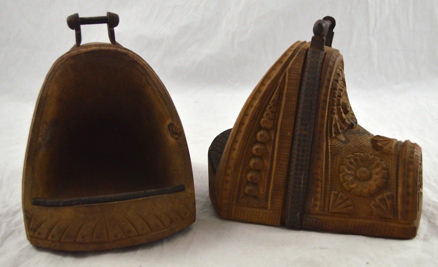 Finely Carved Mongolian Stirrups: Finely Carved Mongolian Stirrups- Wood and Iron. 7 1/2'' high. Very good condition.