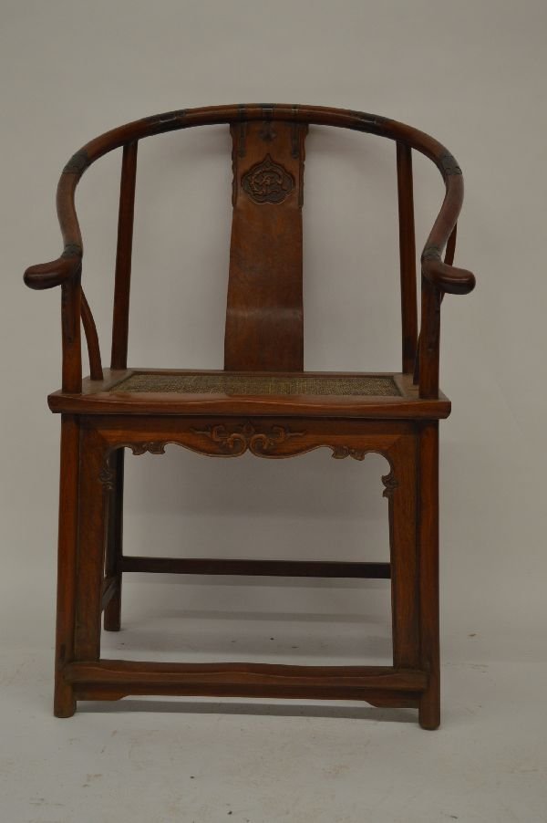 Huanghuali Arm Chair: Huanghuali arm chair, soft-mat cane top and splat decorated with carved dragon pattern, and apron with floral carving. 40” x 19” x 27”