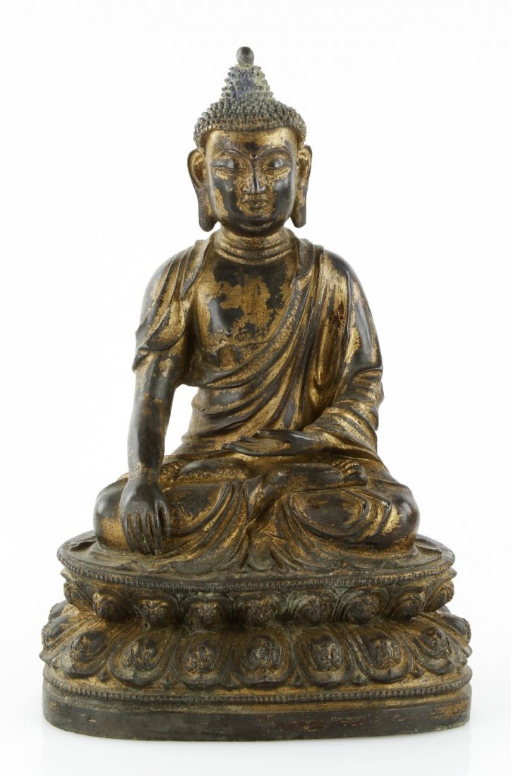 Gilt And Bronze Sakyamuni: Bronze Sakyamuni, Tibet, 19c. Depicting with seated Buddha in double lotus base, hands in Buddhist posture. Opening base. 15”h