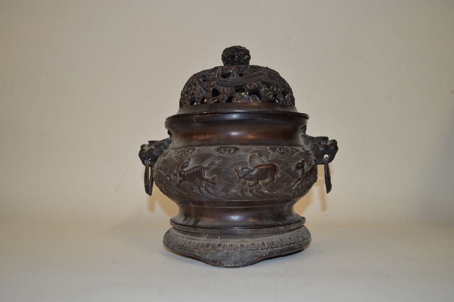 Chinese Antique Bronze Censer: Bronze Censer, China, with carved sea monsters pattern, carved foo-lion heads holder with holding ring, carved bronze cover and stand, carved Chinese character mark on base. 9 1/2”H