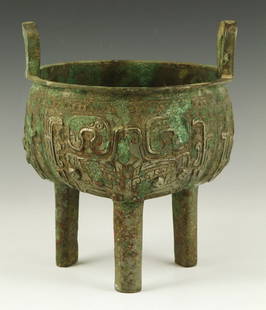 Antique Chinese Bronze Censer: Antique bronze censer, China, with three feet and two handles, incised with elaborate decoration, 8 1/2"h x 7"w.