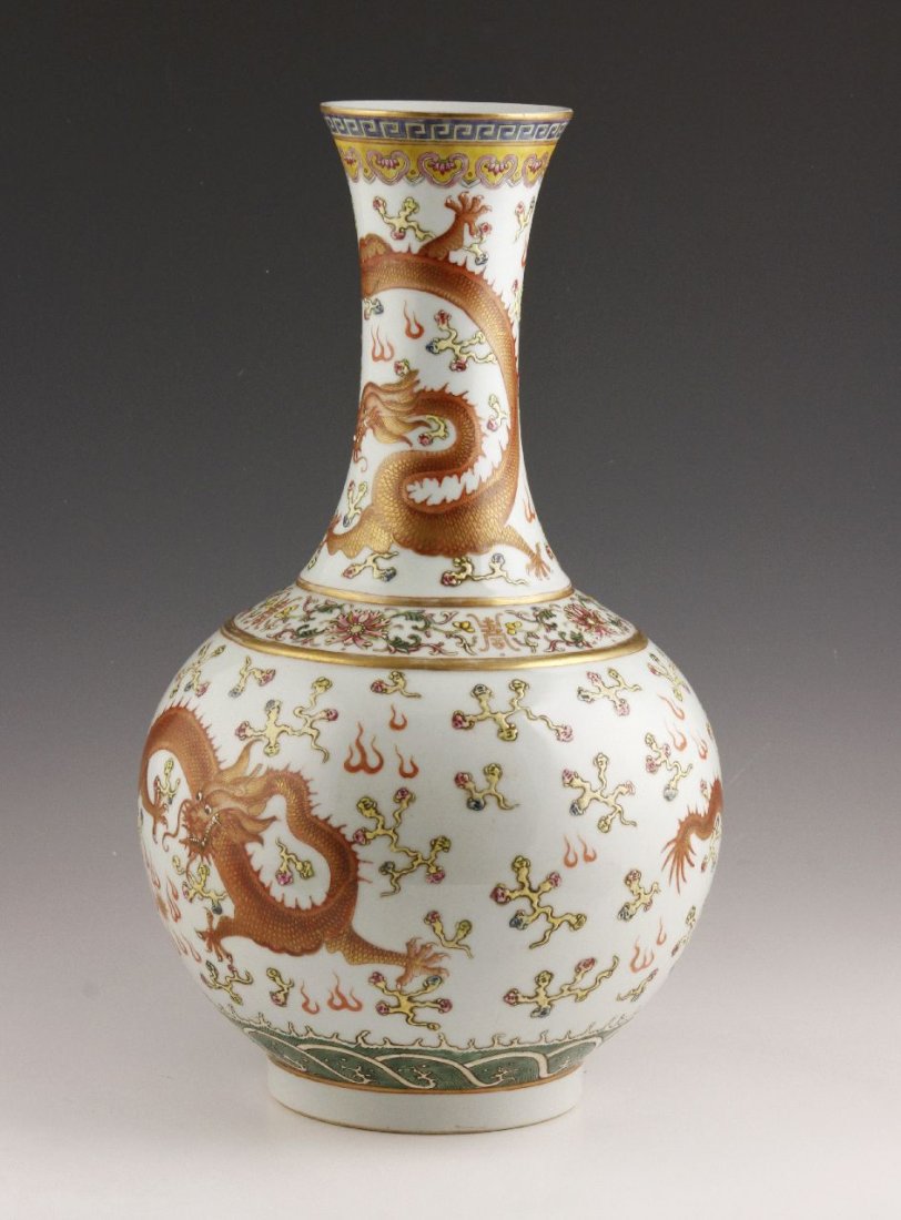 Famille Rose Vase: Famille rose porcelain bottle vase, China, later Qing dynasty, decorated with three prominent dragons and other auspicious symbols, With red Qing Guangxu mark on base. 15 1/2"h.