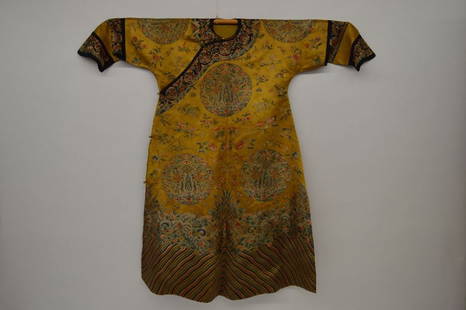 Chinese Antique Dragon Robe: Dragon Robe, China, Qing Dynasty, Decorated with woven with roundels of auspicious motifs and a wave border on a yellow background, with an imperial yellow silk lining