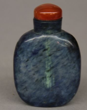 Blue Peking Glass Snuff Bottle: Blue Peking glass snuff bottle, China, round shape, with white spots on blue ground, a red bottle cap.3'