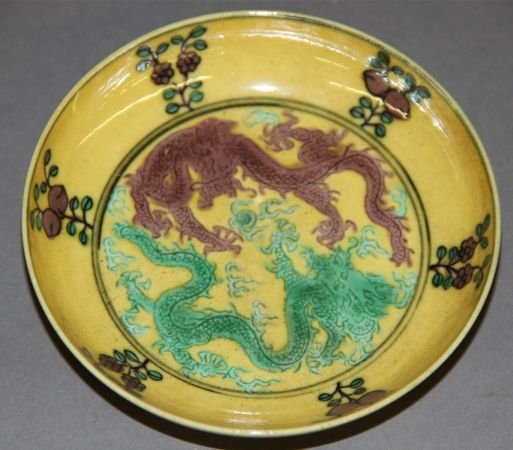 Yellow Glazed Famille Rose Plate: Famille rose plate, China, yellow glazed, decorated with a brown dragon and a green one, Guangxu mark on base. 4"D