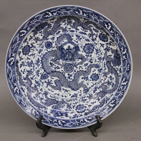 Large Blue And White Porcelain Plate: Large blue and white porcelain plate, China, decorated with flying dragons and pearl surrounded by continuous floral motifs and waves, Qianlong mark on base. 17"