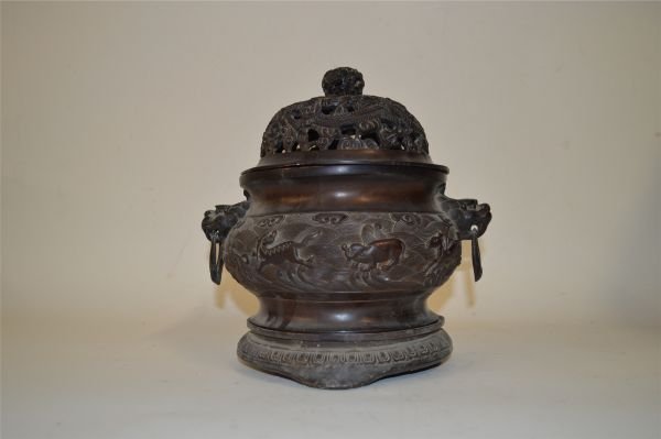 Bronze Censer: Bronze censer, China, two animal head shaped handles with loose rings, decorated with openwork and flying dragons amist clouds on cover and carved waves on body, Xuande mark on base.9 1/2" X 9 1/2"