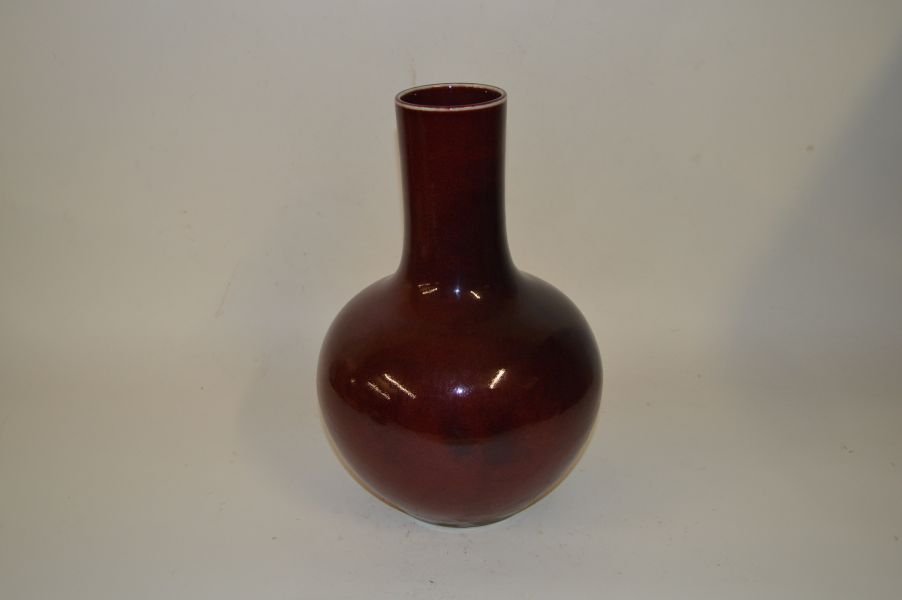 Red Glazed Bottle Vase: Bottle Vase, China, Red glazed with long neck shaped and Four Chinese character mark on base, later 19c. 13 1/2”H