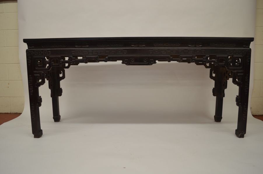 Delicate Carved Zitan Altar Table: Zitan table, China, Qing dynasty, the shoulder and pierced apron with cloud decoration, with diamond-shape underside and scroll feet. 32”H x 71”L x 21”W