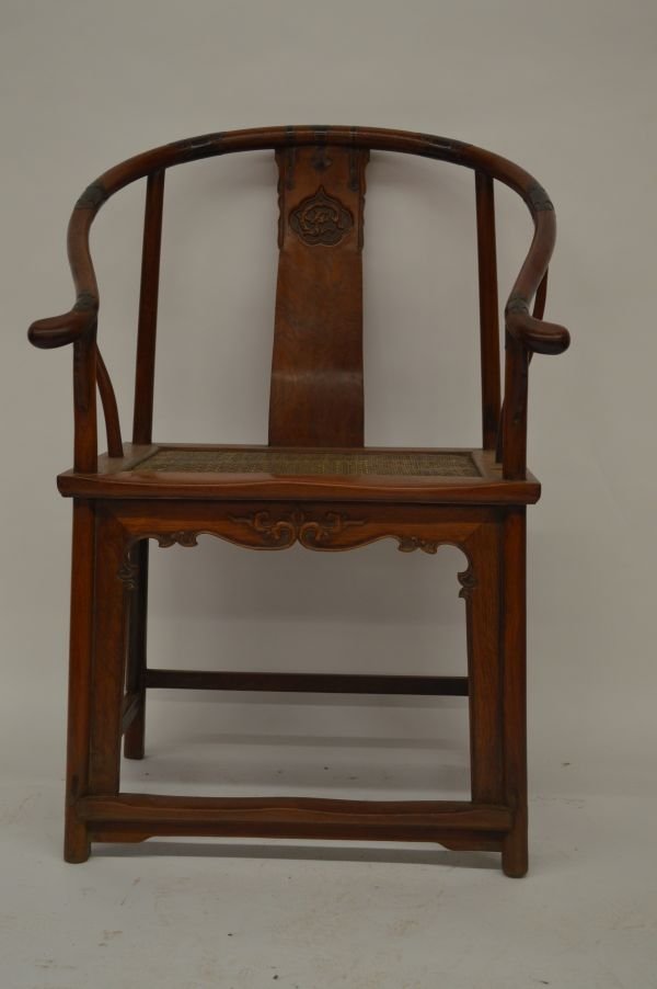 Huanghuali Arm Chair: Huanghuali arm chair, soft-mat cane top and splat decorated with carved dragon pattern, and apron with floral carving. 40” x 19” x 27”