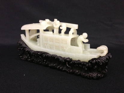 Carved Chinese Jade Boat Sculpture: Decorated with boart shapped white jade scapture Boys Figure, with carved fitted Zitan wood stand as sea wave shaped. 3 1/4” H x 8 1/2” L.