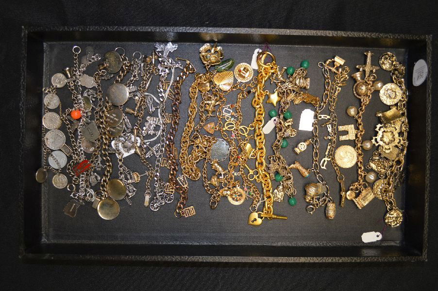 LOT OF 20+ GOLD TONE AND SILVER TONE CHARM BRACELETS: LOT OF 20+ GOLD TONE AND SILVER TONE CHARM BRACELETS; SOME CHARMS ARE STERLING
