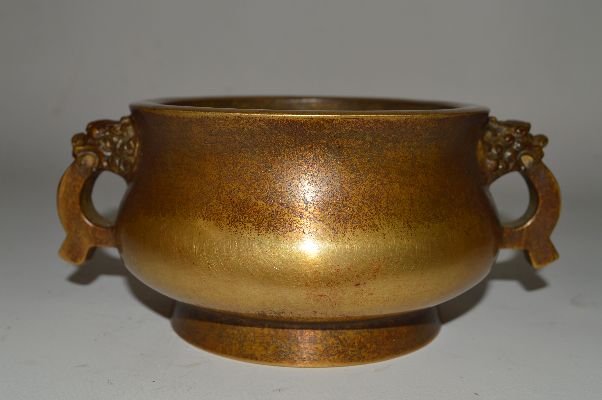 Chinese Bronze Cencer: Bronze censer, China, republic period, round shaped and dragon shaped holder, carved Ming Xuande mark on base. 3” x 7 3/4”