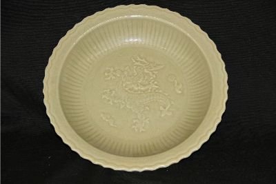 Large Ming Green Glazed Porcelain Plate: Green glazed porcelain plate, China, Ming Dynasty. Decorated with a flying dragon amist flames and clouds in the center. 13" X 3"