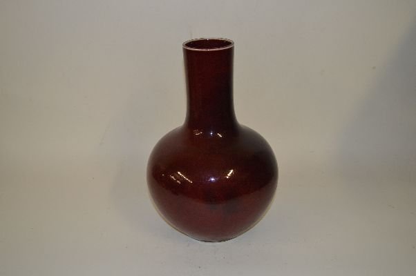 Red Glazed Bottle Vase: Bottle Vase, China, Red glazed with long neck shaped and Four Chinese character mark on base, later 19c. 13 1/2”H