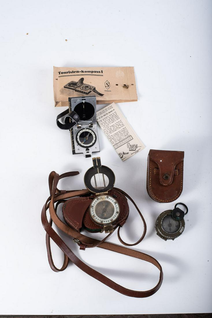 WWII MILITARY ISSUE COMPASS, three in the lot: WWII MILITARY ISSUE COMPASS, three in the lot WWII British compass in leather pouch. Made in brass. USA-issue compass in pouch and German-made compass that was bought by the Union Governmentt of South