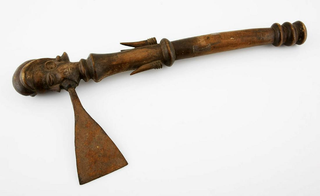 A CHOKWE AXE, ANGOLA: A CHOKWE AXE, ANGOLA The shaft with duiker horns and surmounted by a carved male mask 43cm long