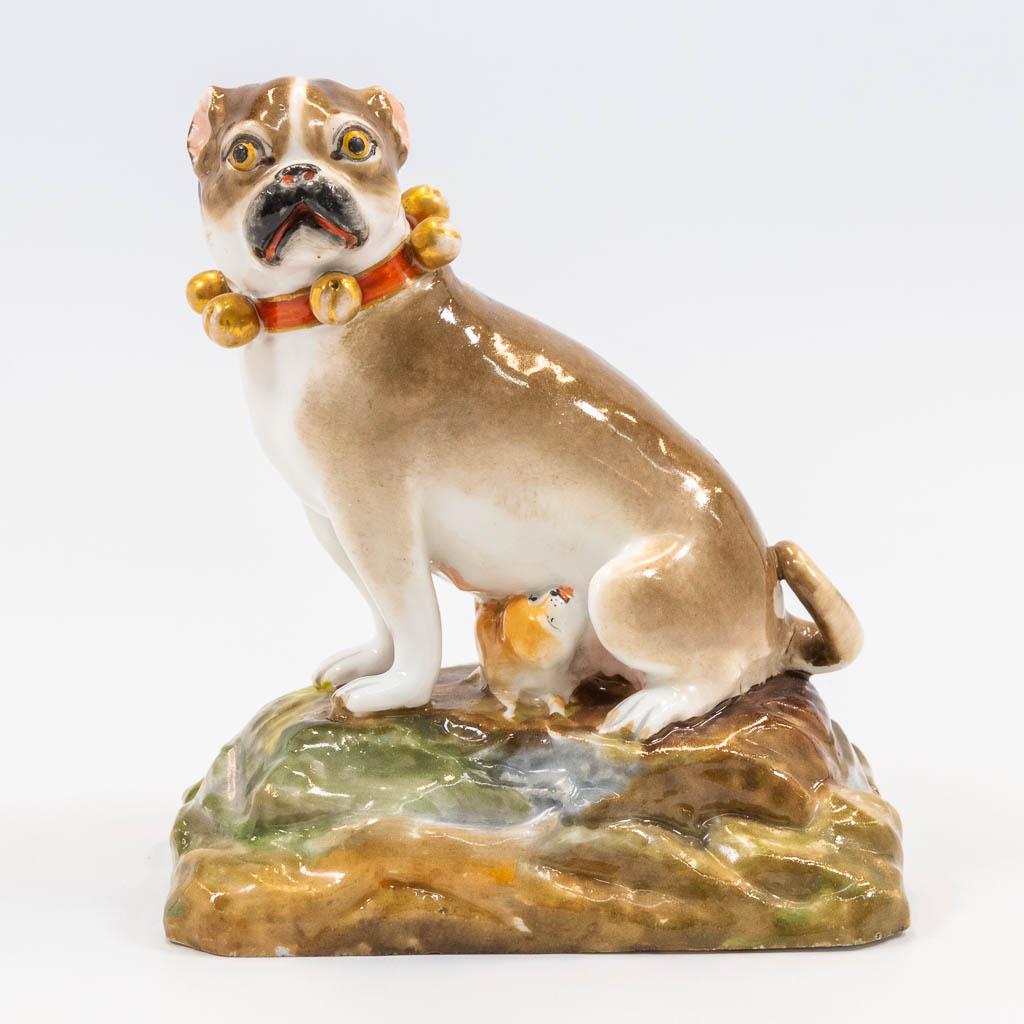 A porcelain statue of a dog with a puppy marked Jacob: A porcelain statue of a dog with a puppy marked J.P. Limoges. 19th century. (8 x 13 x 15 cm)
