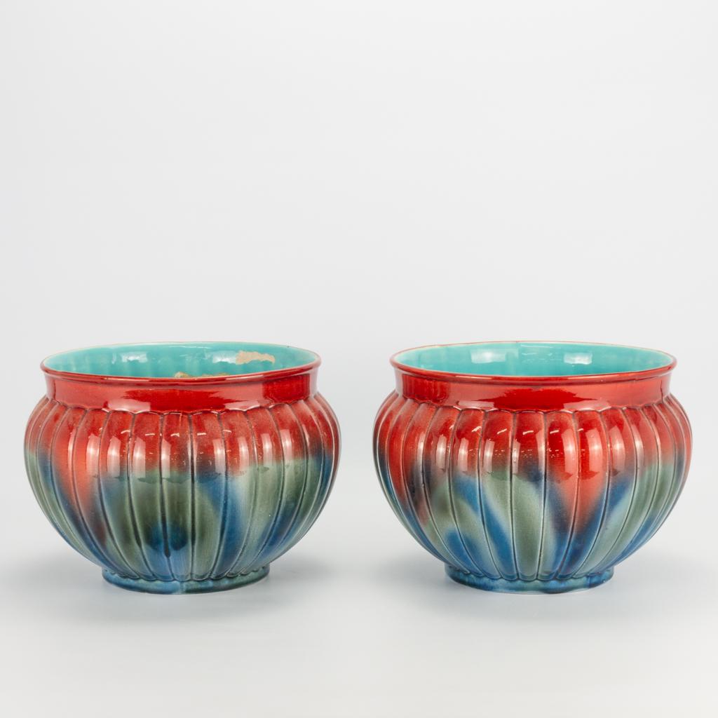 A pair of glazed cache-pots made in faience and during: A pair of glazed cache-pots made in faience and during the art deco period, marked Sarreguemines. Around 1920. condition: chips. (19 x 27 cm)