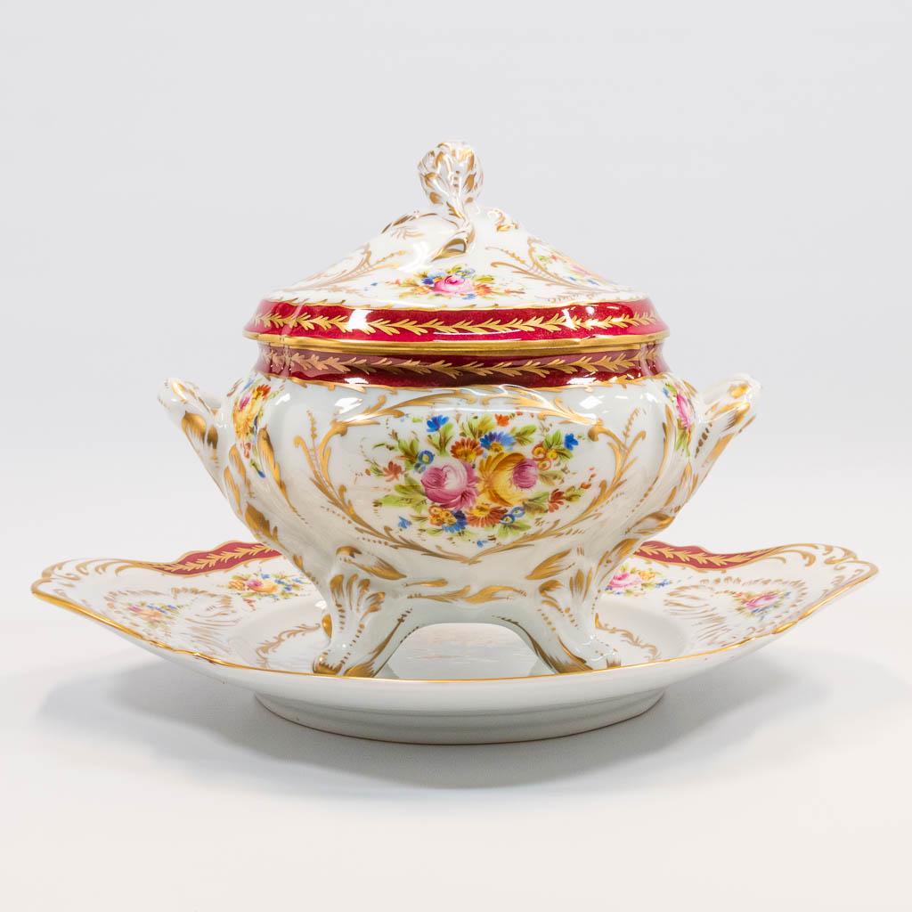 A large porcelain Tureen made with hand-painted flower: A large porcelain Tureen made with hand-painted flower decor and with a lid on a plate. Marked JD Limoges. The second half of the 20th century. (33 x 41 x 28 cm)