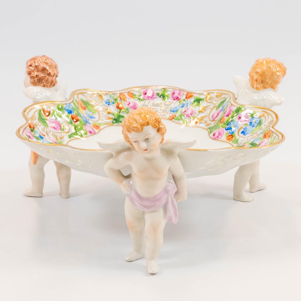 An ajoured porcelain basket, carried by putti, with (1 of 16)