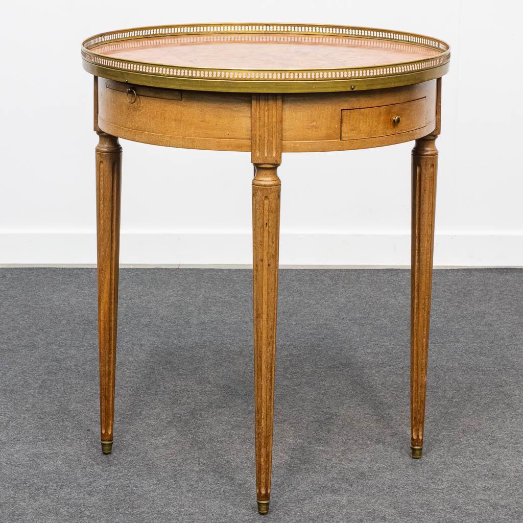 A side table made of wood with a marble top. The second (1 of 16)