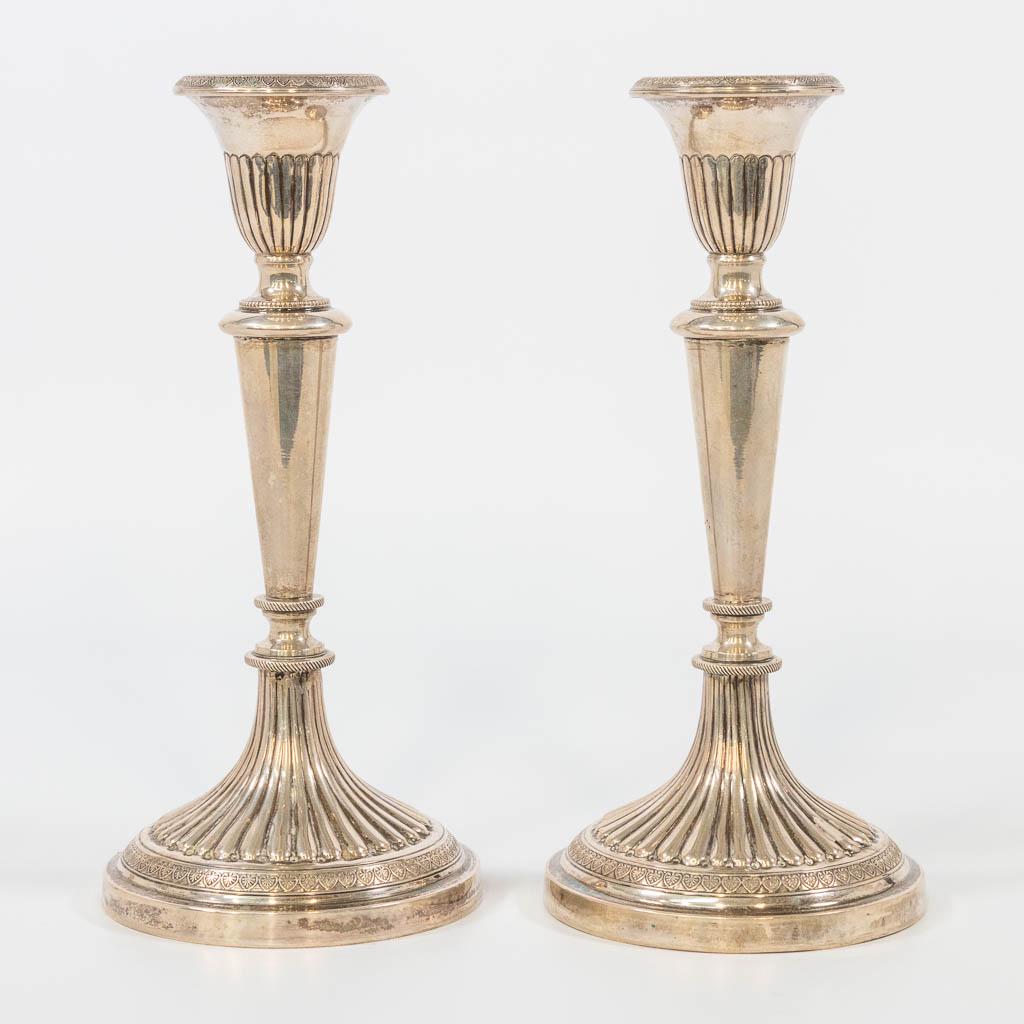A pair of candlesticks made of silver and marked 800. (1 of 11)