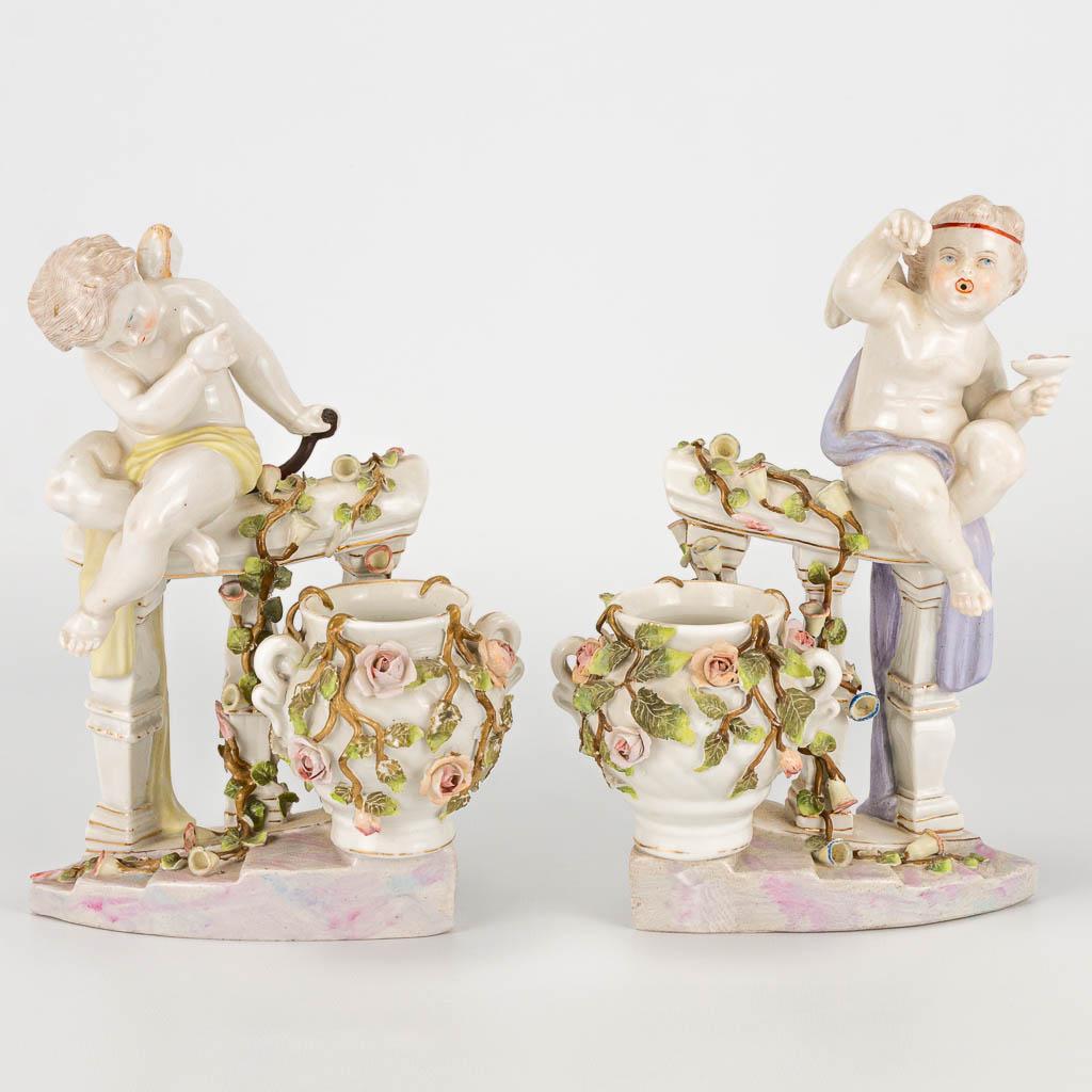 A pair of porcelain figurines of angels on a handrail (1 of 20)
