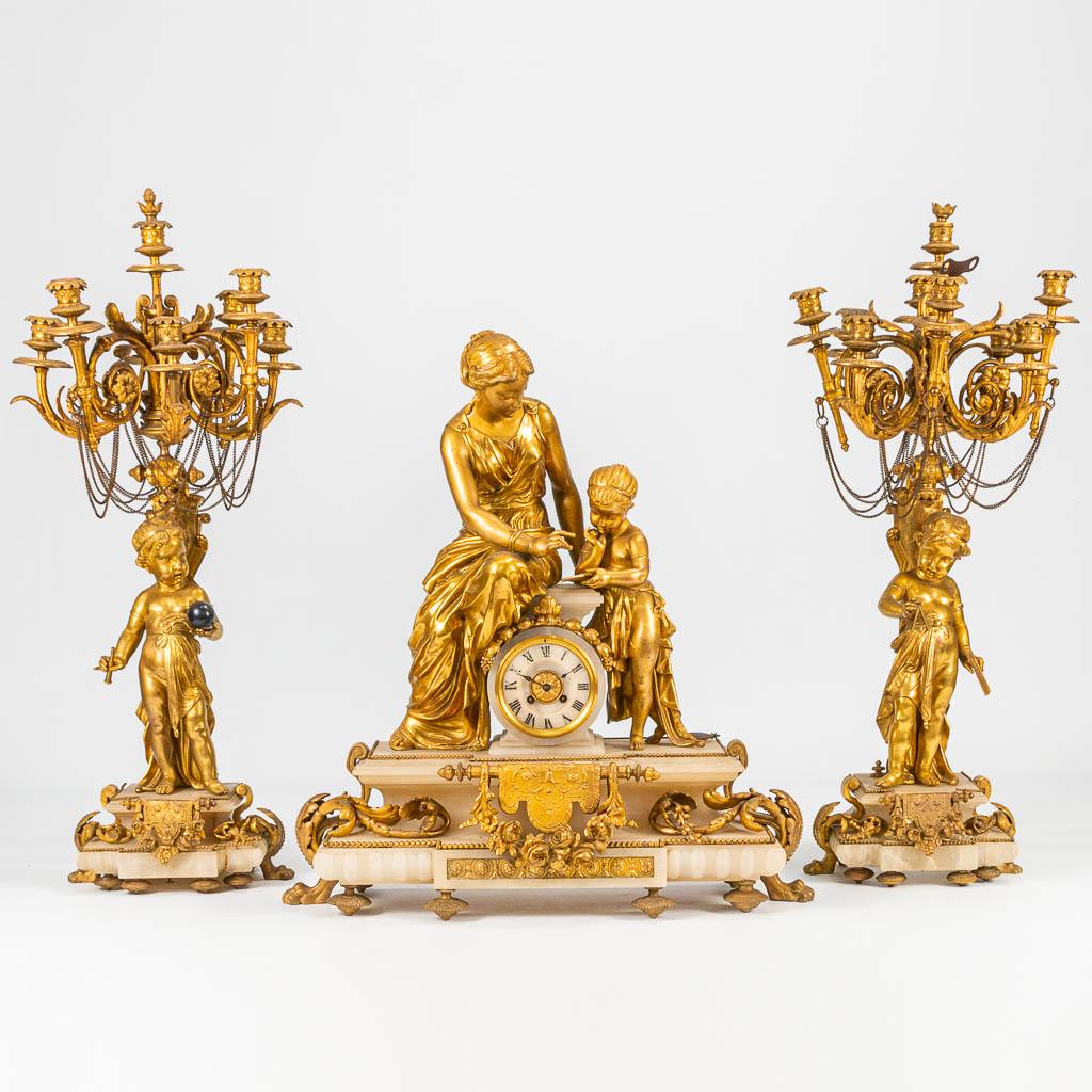 A 3 piece gilt garniture clock, decorated with putti a (1 of 20)