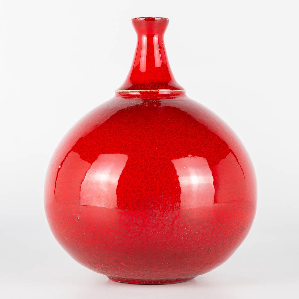 A vase made of red glazed white ceramics and probably (1 of 10)