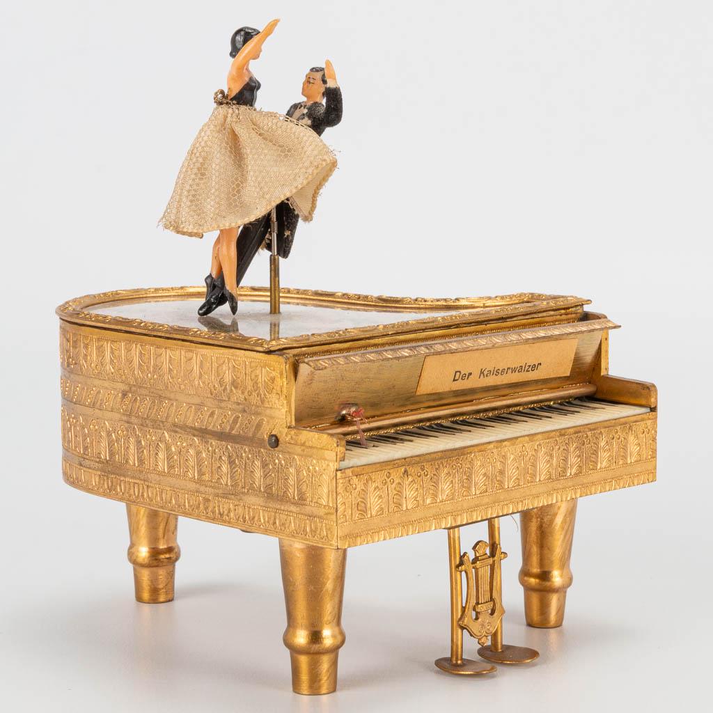 A music box of a piano made of metal with dancing: A music box of a piano made of metal with dancing couple. (11 x 9 x 12 cm)