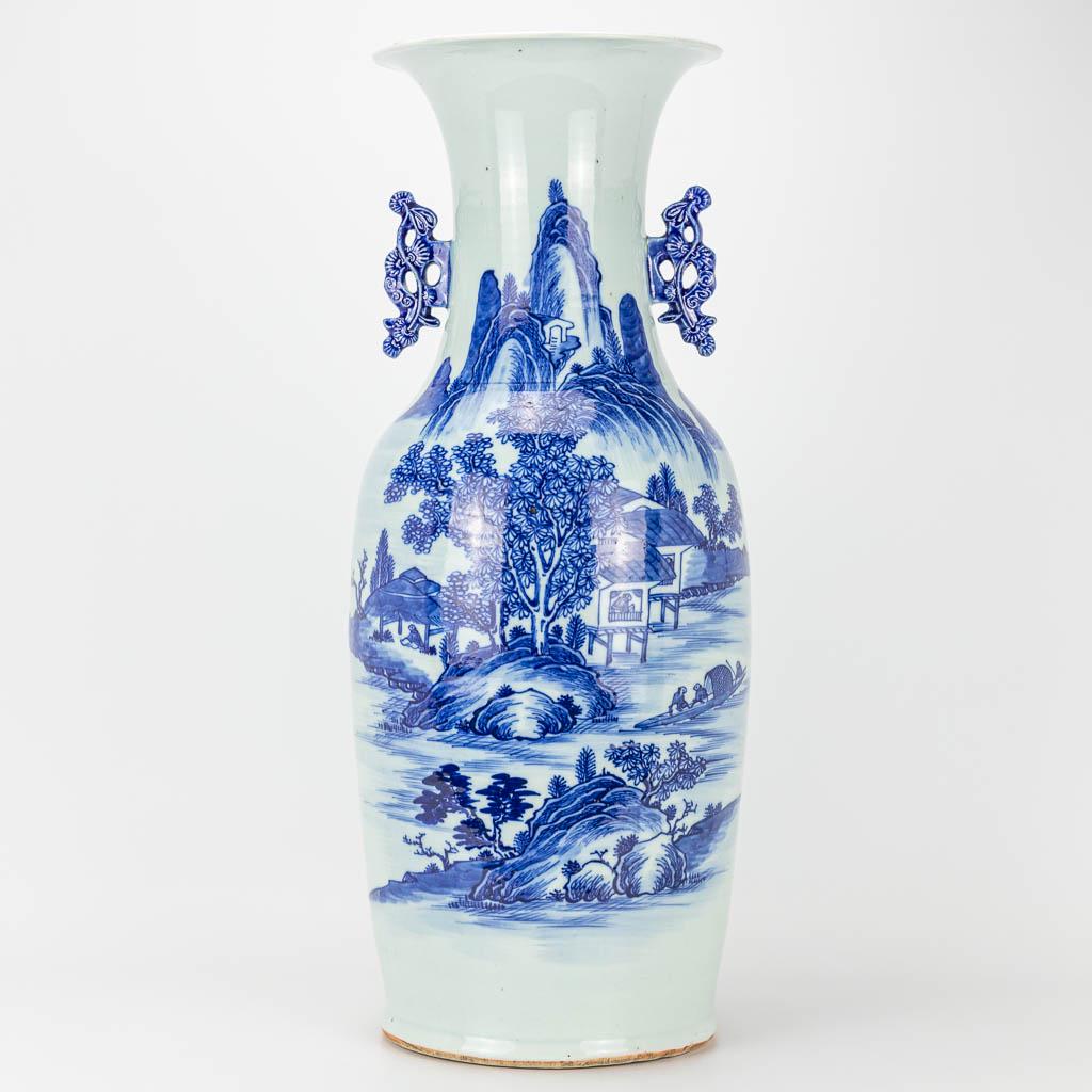 A vase made of Chinese porcelain with a blue-white: A vase made of Chinese porcelain with a blue-white decor of a landscape. 19th/20th century. (58 x 23 cm)