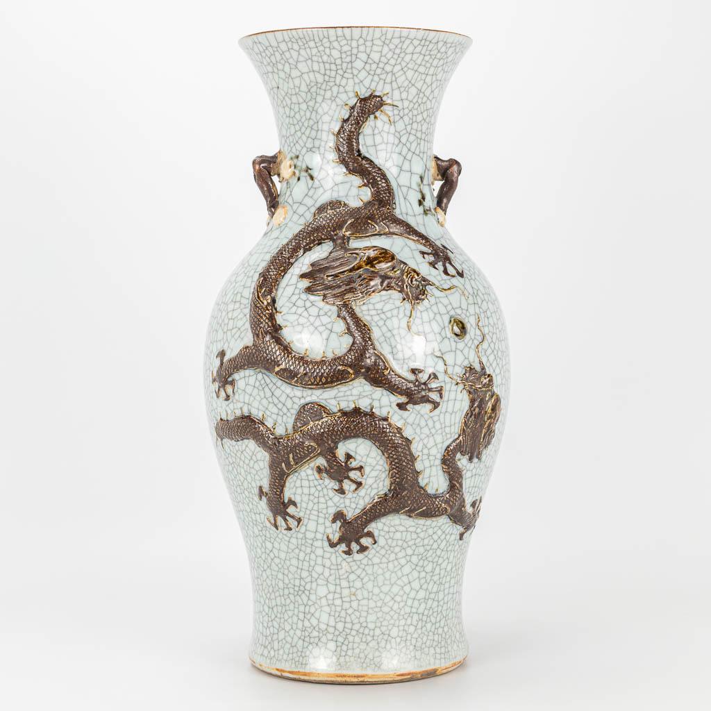 A vase with dragon decor and made of Chinese: A vase with dragon decor and made of Chinese earthenware, Nanking. (43 x 21 cm)