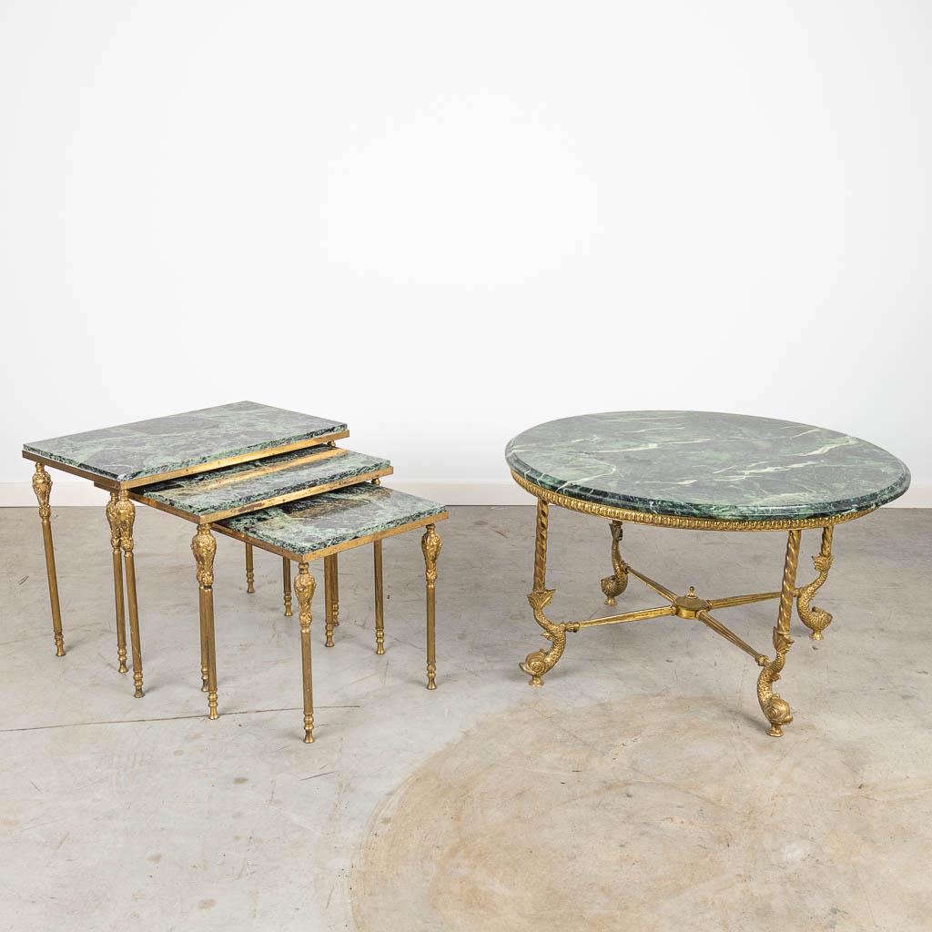 A coffee table and set of cigogne tables made of bronze: A coffee table and set of cigogne tables made of bronze with a marble top. Around 1960. (34 x 55 x 42 x 78 cm)
